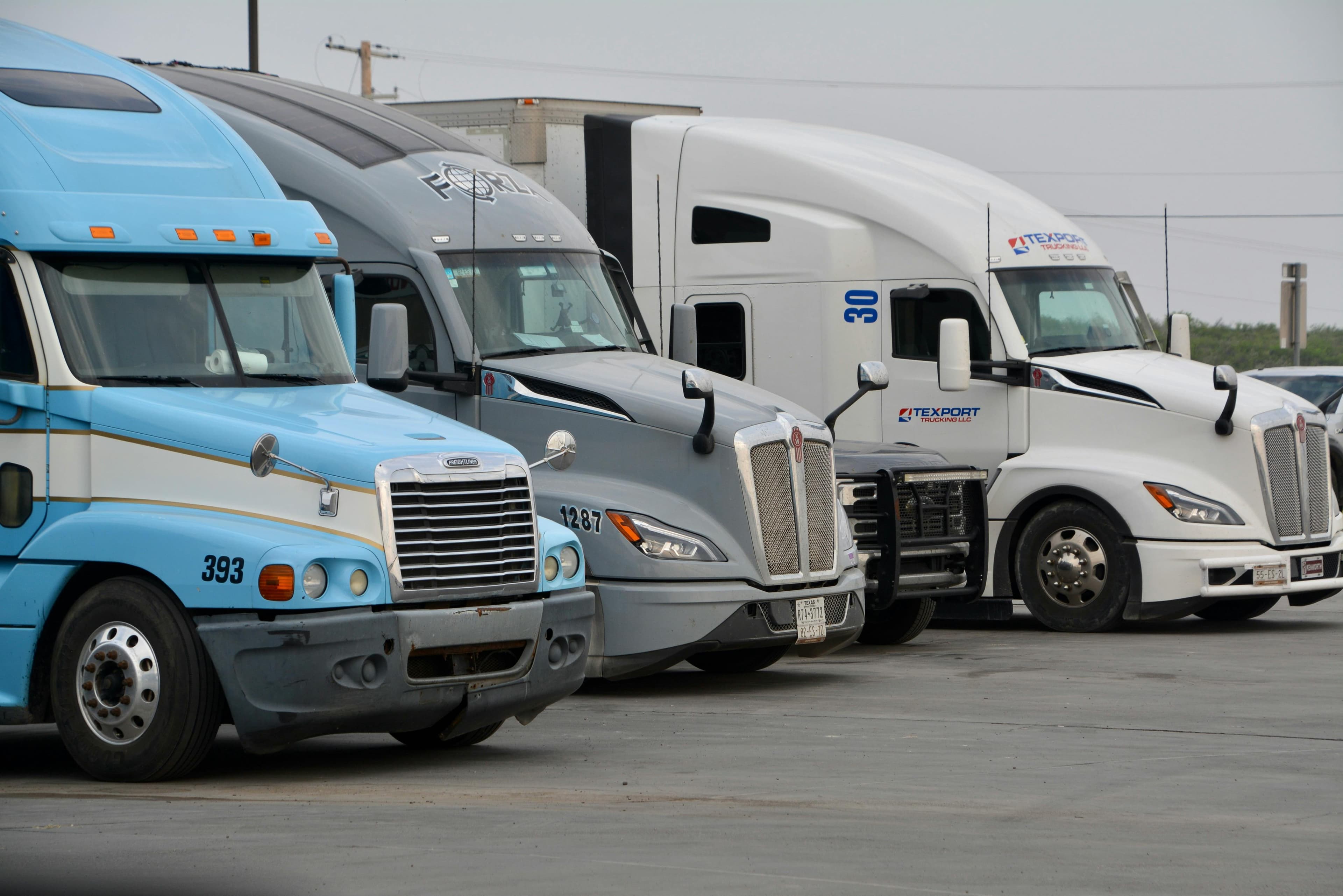 Row of semi-truck cabs at a fleet terminal