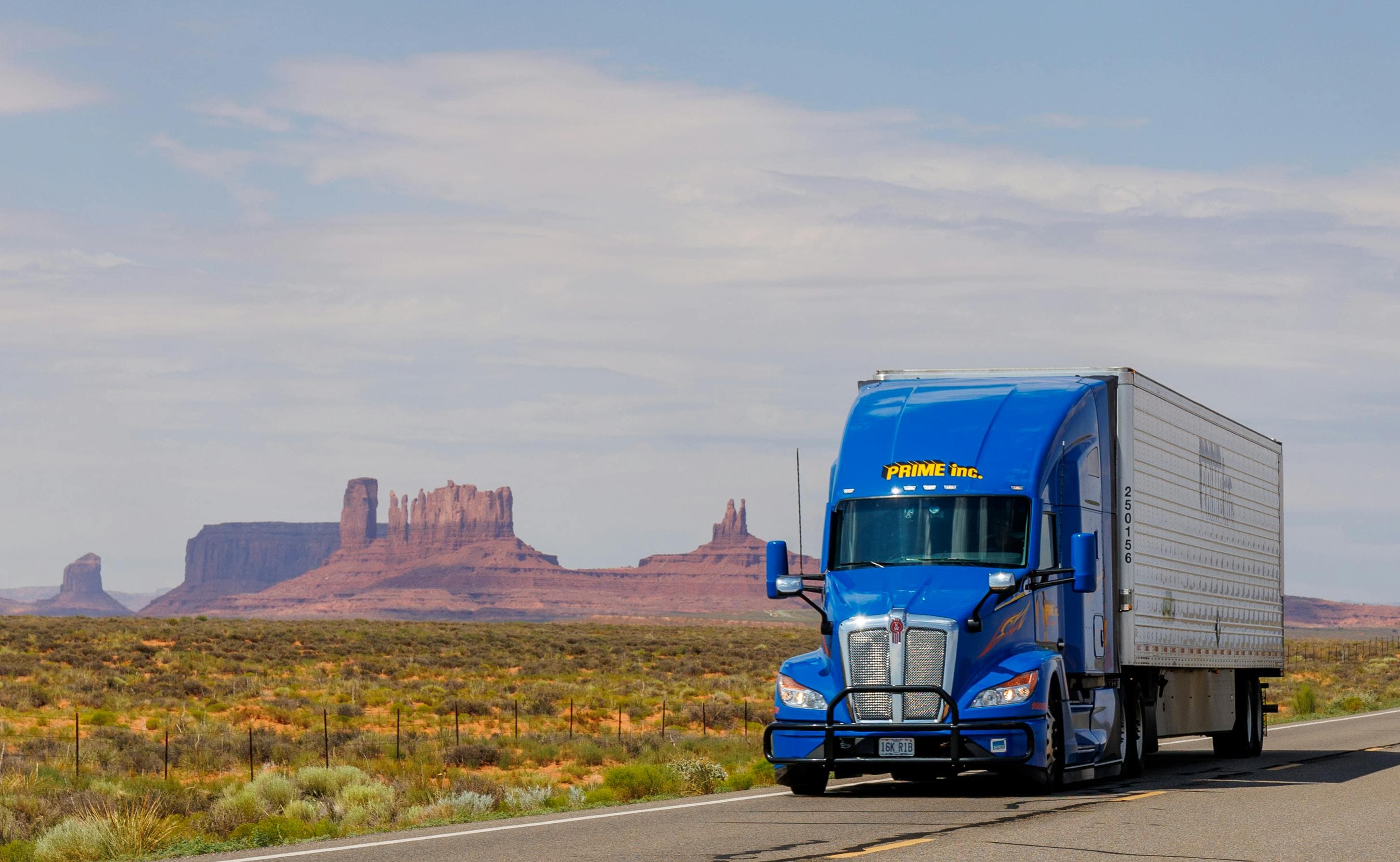 Blue Prime Inc. semi-truck driving past Monument Valley